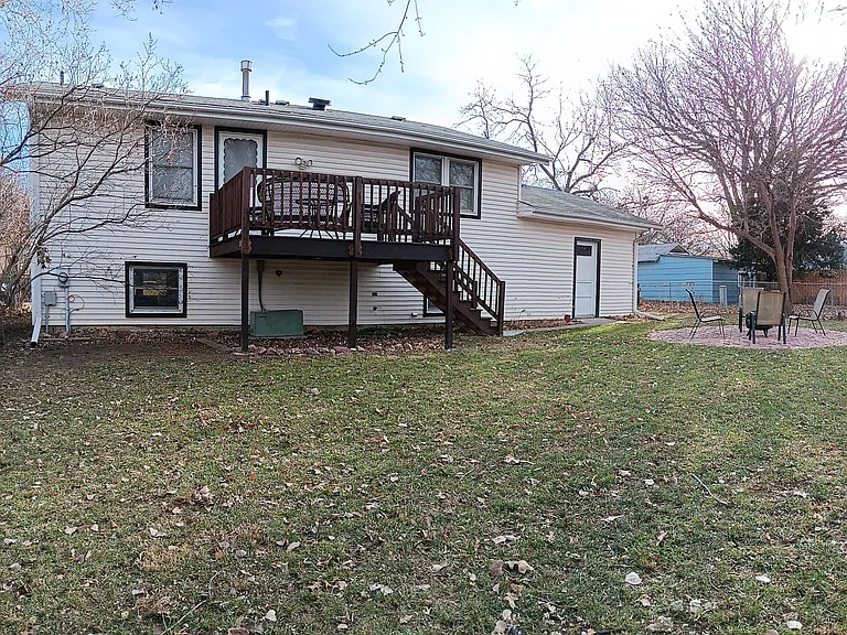 Fenced backyard with deck.