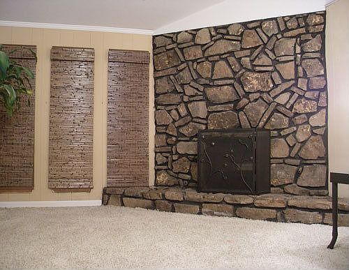 Wood burning fireplace in living area with vaulted ceilings
