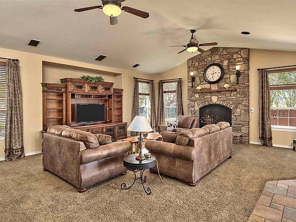 The massive stacked stone fireplace surround is the focal point of this home's f