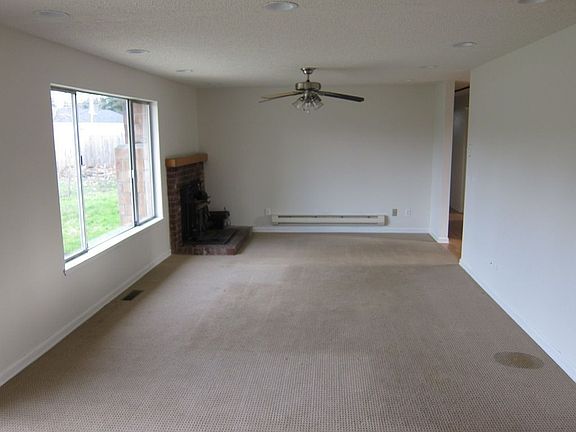 Spacious Living Room w/ Cozy Brick Fireplace