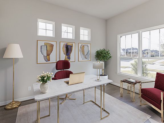 Study featuring large windows allowing for plenty of sunshine