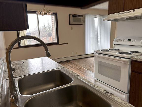 The kitchen offers stove, range, refrigerator, and dishwasher with updated counter tops and fixtures