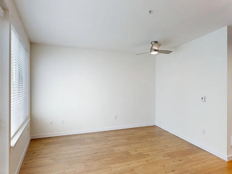 Spacious apartment Bedroom with Wood-Style Flooring.