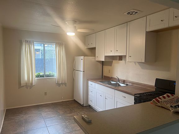 Spacious kitchen with new cabinets and cooling fan