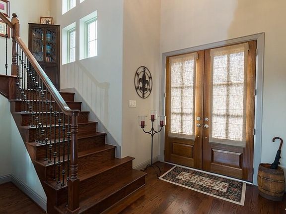Plank hardwood floors welcome you into this pristine home. (Please note, the cabinet on the stair landing is not built-in and does not remain with the home)