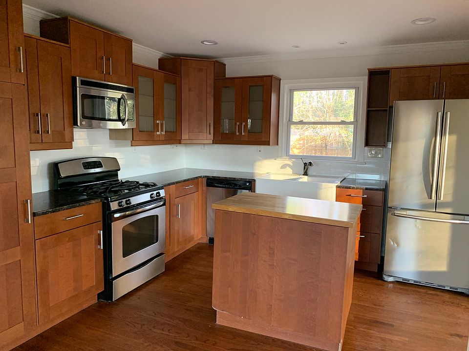 Beautiful kitchen with granite countertops, new stainless steel appliances, and small island