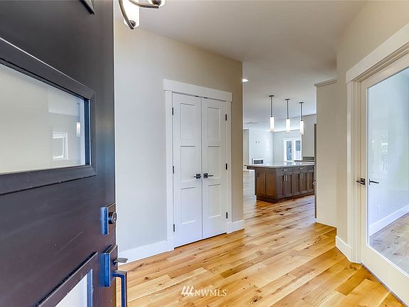 The foyer leading into the home. The versatile flex room with glass door is on the right.  