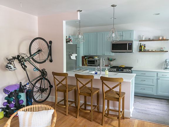 There is a permanent small white mini split unit on the wall above the bike!