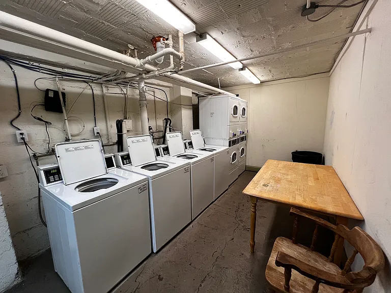 Well-lit laundry room in basement.