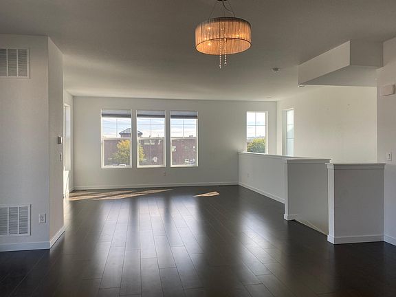 Dining area and living area; stairs to the downstairs at right