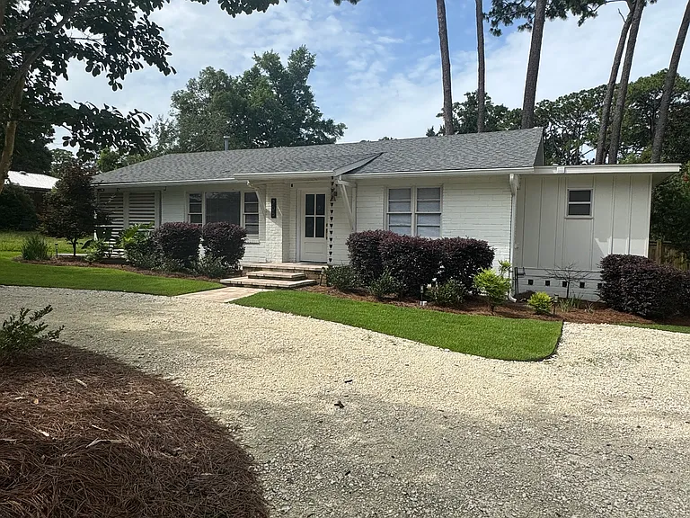 Large circular driveway with ample parking.