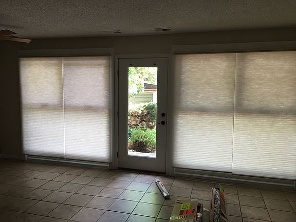 Living room with duet blinds and new tile floor.