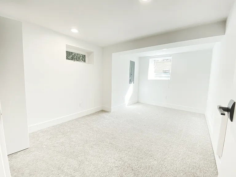East bedroom, unfurnished, with new window.