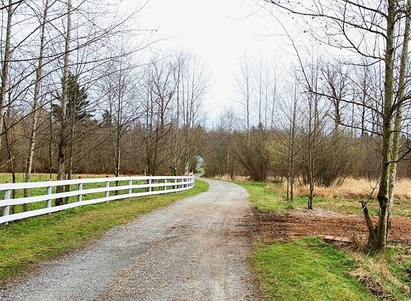 Private drive right off SE 244th.  Fenced pasture on left.  Acre