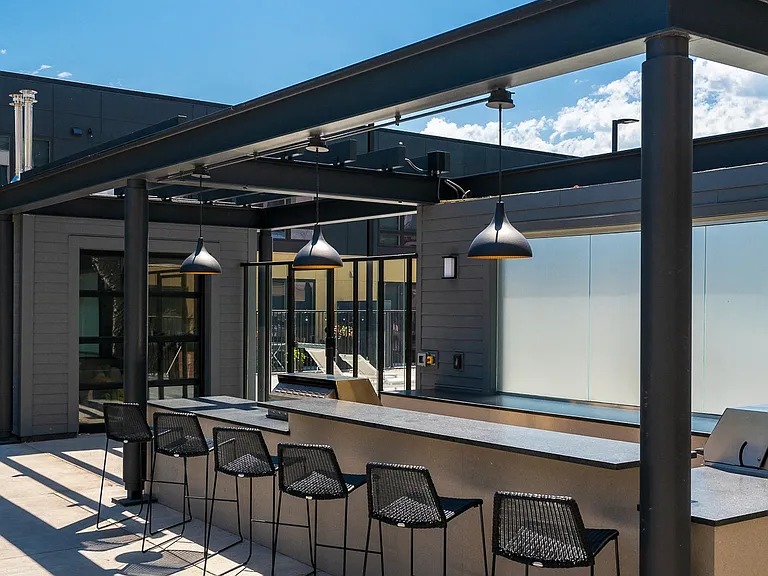 Entertain or dine al fresco at the spacious outdoor bar and seating area with grills.