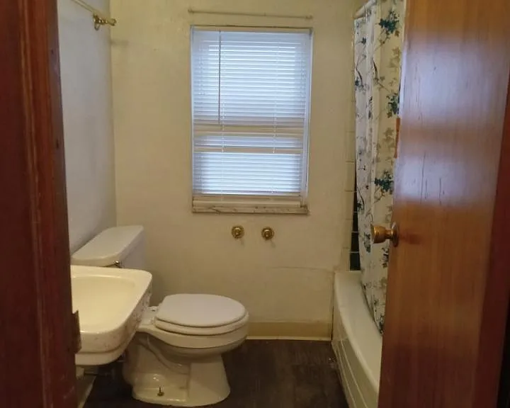 bathroom - has bathtub with shower.