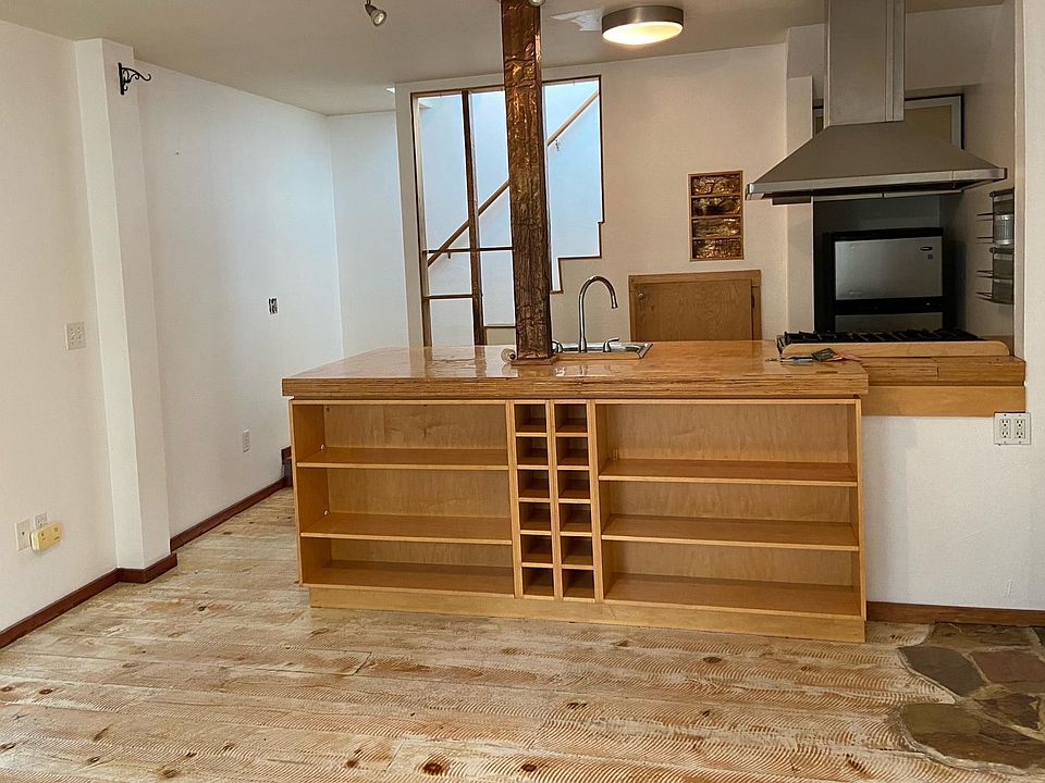 view of kitchen from dining area. Built-in wine racks and cabinets for dishes are here, and there are closed cabinets in the kitchen