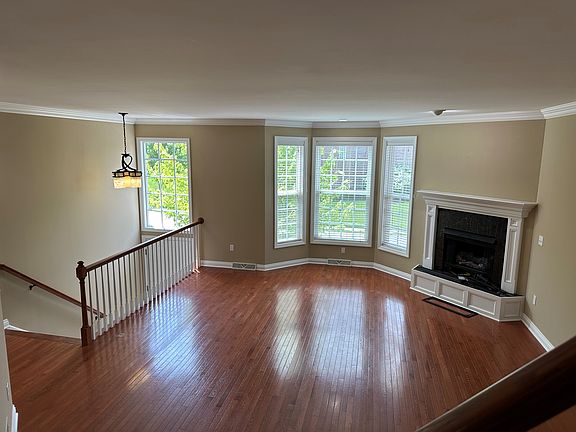 Open floor plan living area with a lovely bay window and fireplace