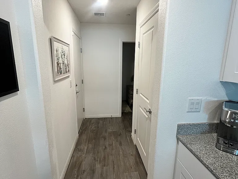 Hallway from the kitchen to the half bath and the garage
