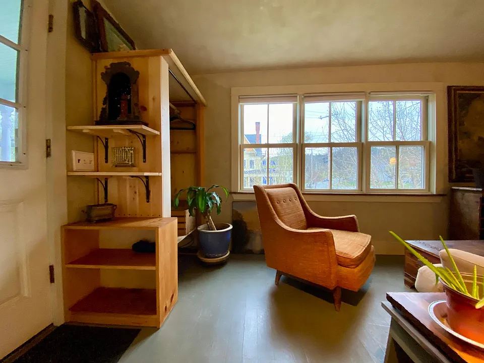 view from kitchen into little LR alcove with door onto porch