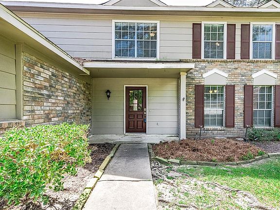 Approaching the front door you will see the beautiful brick elevation, dark stained shutters, and covered front porch!
