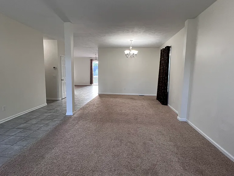 Living and Dining rooms with carpet.