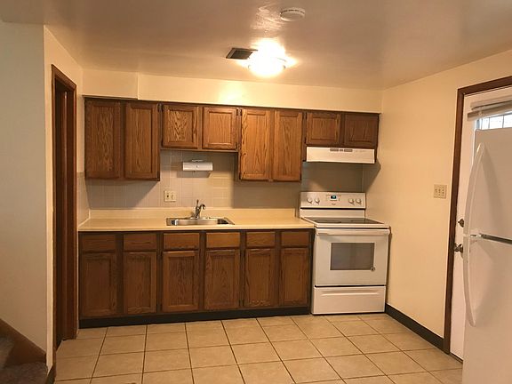 Kitchen with range and refrigerator