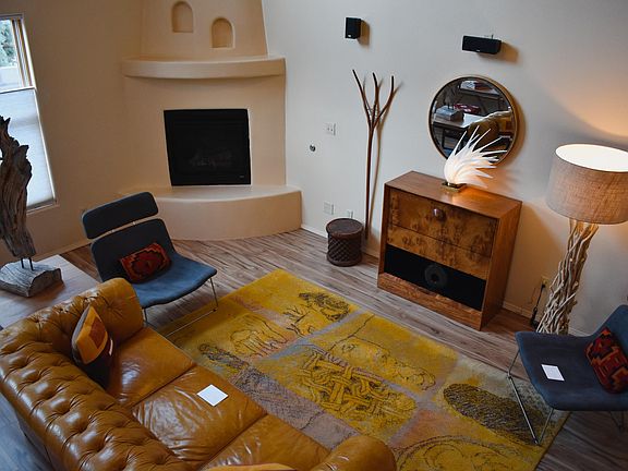 The light filled living room is spacious and it feels grand. It is sure to impress all of your friends.