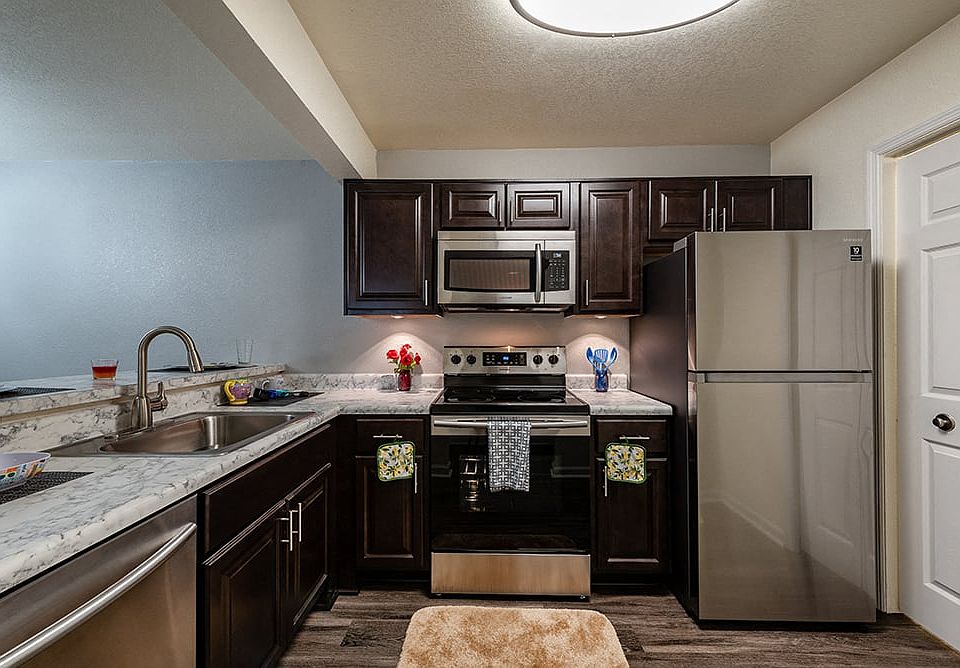 Kitchen with Dark Cabinets and Stainless Steel Appliances