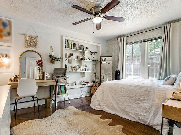 Bedroom has hardwoods and built in shelves.