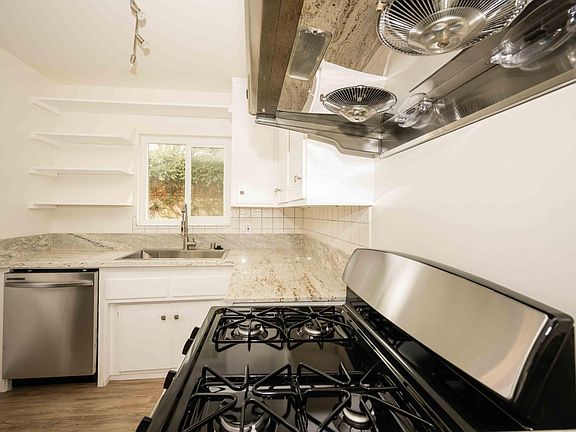 Kitchen with New Stainless Steel Appliances and Track Lights