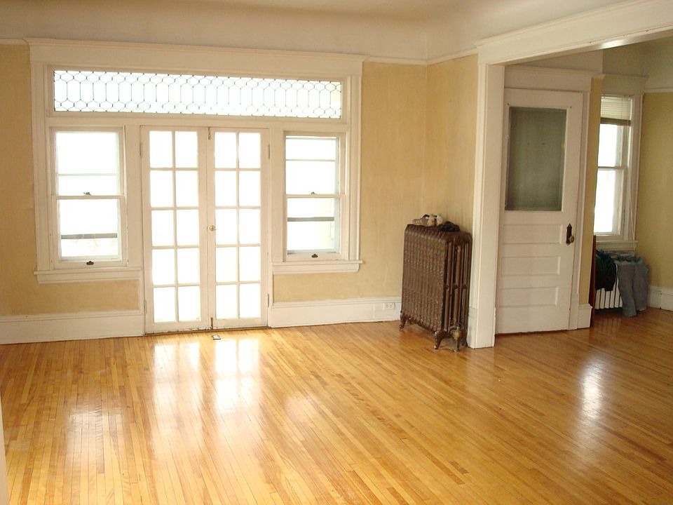 Sunny front room with doors to screened porch.