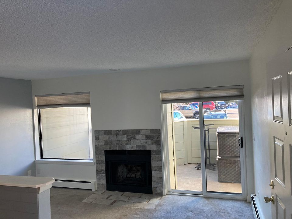 This is the living room, front door is right side of picture. Sliding glass door to access outside deck/sitting area. Fireplace and then kitchen to the left. I am standing in a small area where we usually set a table for eating. Is also a bar/eating area.