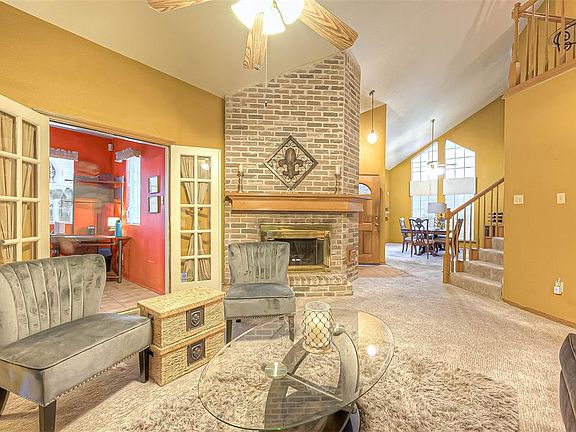 Living room is open to the formal dining and the secondary flex room that is currently being utilized as a den.