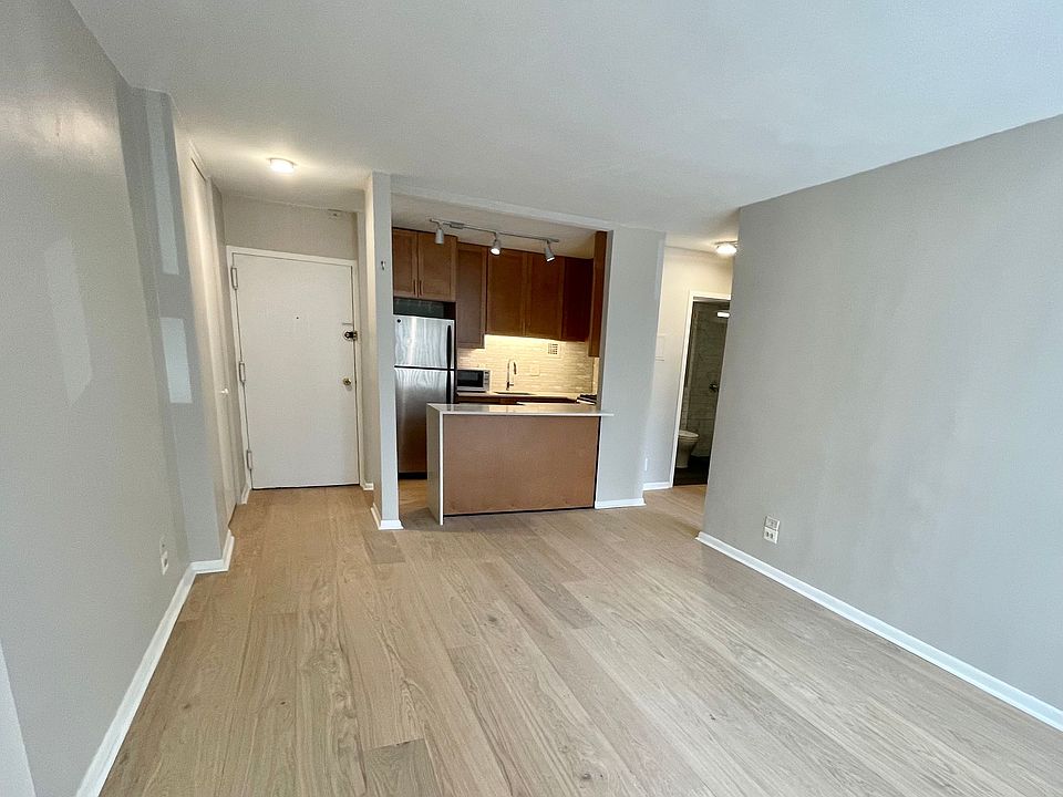 View of kitchen and entry from living room.