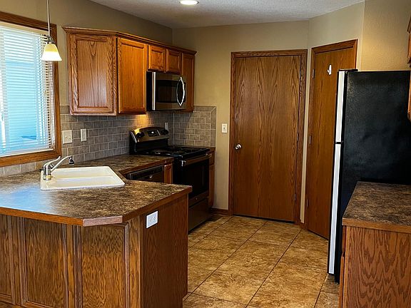 Kitchen, with left door to launcry & garage exit, Right door to pantry