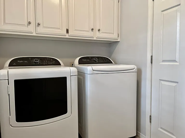 Laundry area comes with newer Whirlpool washer and dryer plus storage. This is a must see before it is gone!