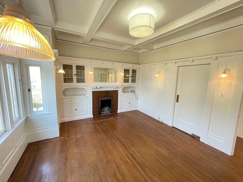 Living Room / Dining Room with Built in Cabinets on Both Sides of Decorative Fireplace