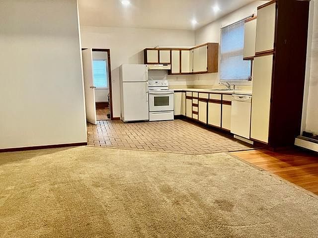 Bright open living space adjoins kitchen.