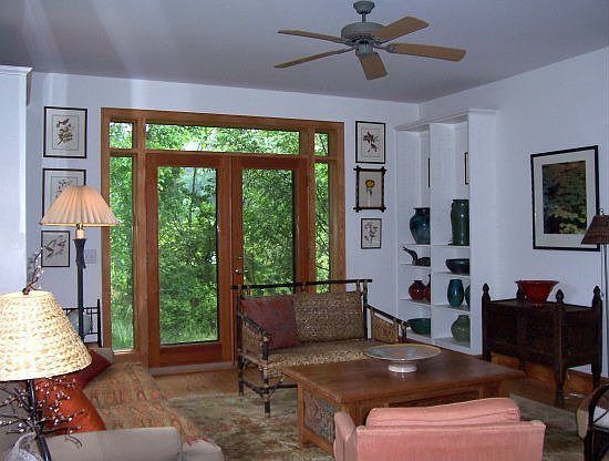 Living room boasts custom built-ins and views of the lovely gardens