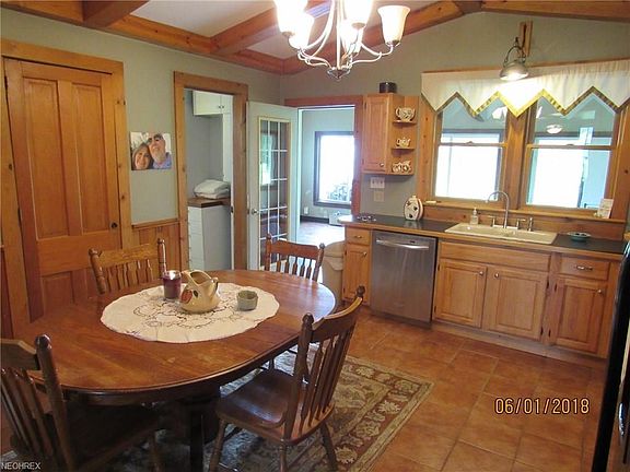 Beautifully updated kitchen looking toward the great room. Ceramic tile floor, Kraft Maid hickory cabinets w/Wainscoating made from wood from the house.Full bath off kitchen.