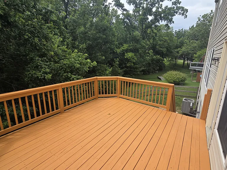 Large refinished deck looking over a private back yard.
