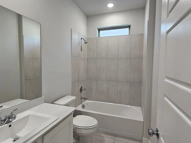Clean, modern guest bathroom with high-quality tile work and contemporary finishes