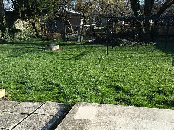 Large fenced back yard. Wood deck and concrete patio. Fire Pit. Fenced vegetable/herb garden. Very private.
