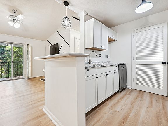 kitchen with view of living room and balcony