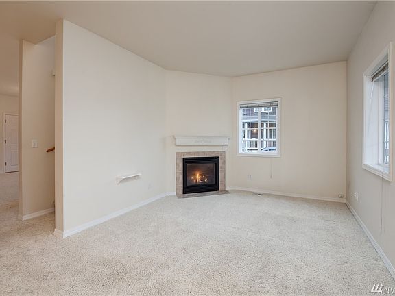The entry opens directly into the living room, with a gas fireplace, and freshly professionally cleaned wall-to-wall carpeting