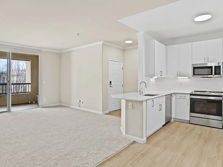 Carpeted Living Room with Balcony