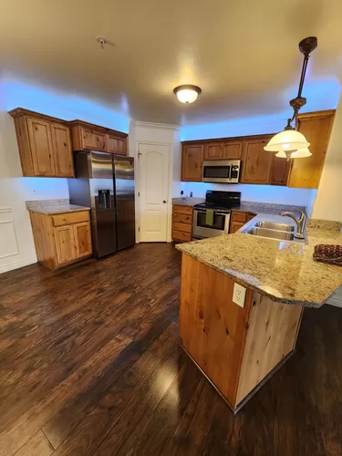 Kitchen with customizable mood lighting. The old flooring is shown; the new is grey. - 685 S 2220 W #2-101