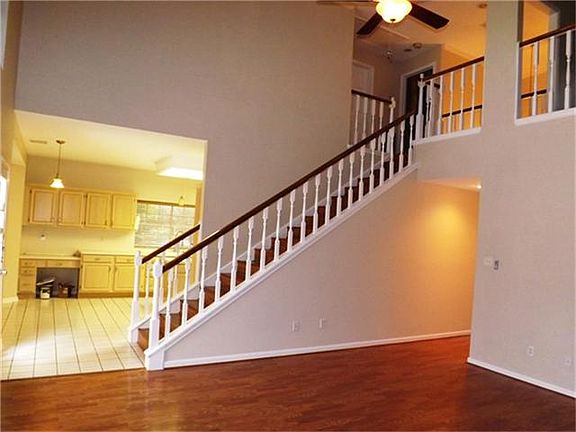 This beautiful home offers a two story living room w/neutral decor and large open areas for entertaining with a warm 'at home' feel.