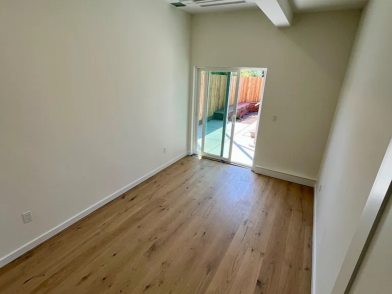 Second Bedroom with sliding glass door leading to the backyard